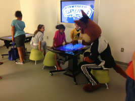SPURS Coyote playing with kids at BiblioTech